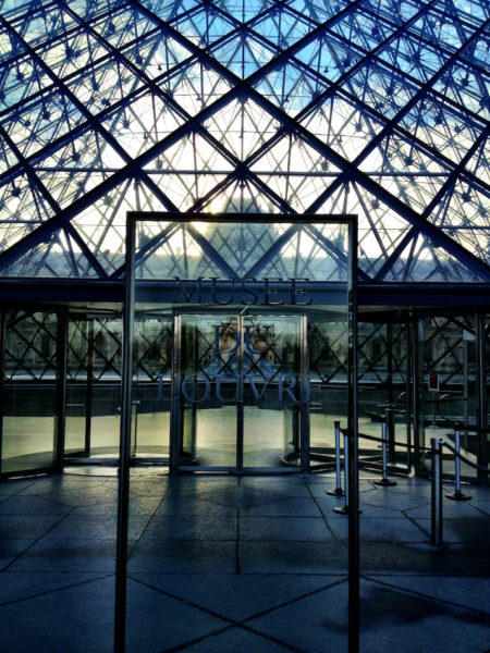 The entrance to the Louvre museum  in Paris through the glass pyramids.