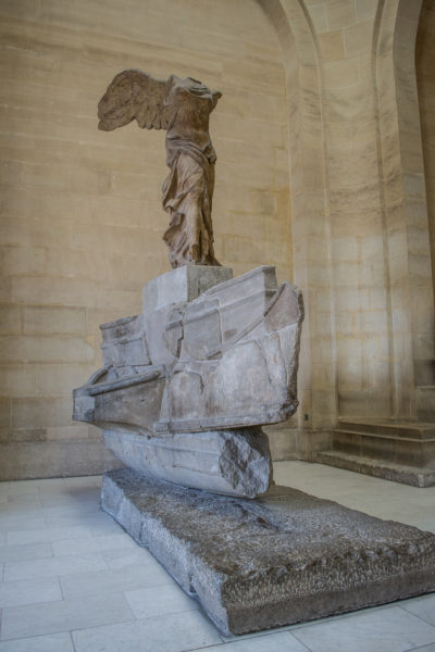 An unclose shot of the Winged Victory of Samothrace statue at the Louvre.