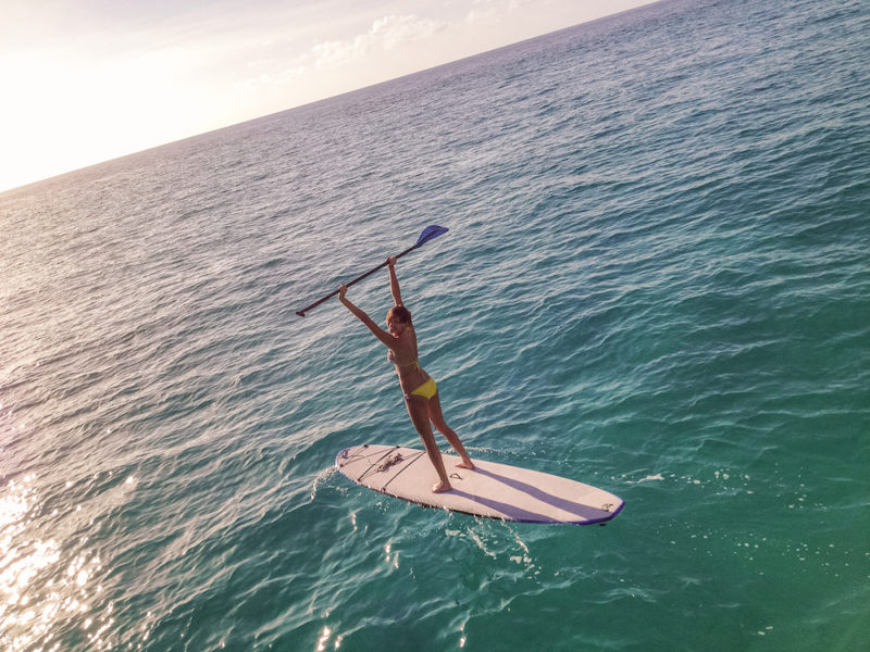 Paddle boarding in the middle of the ocean in the Bahamas.