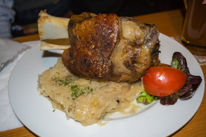 What to eat in Germany: Try Schweinshaxe--roasted pork knuckle on sauerkraut.