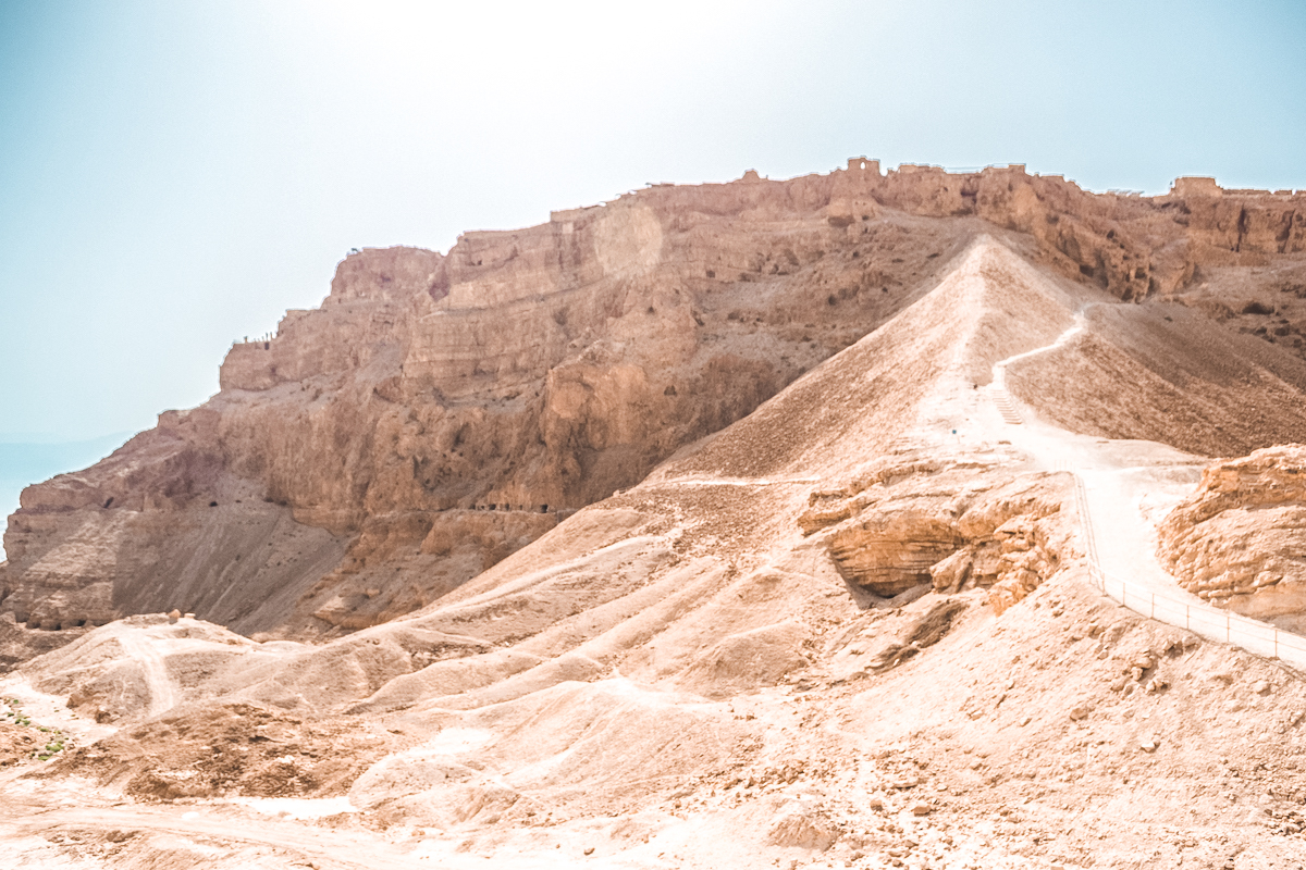 These ancient ruins in Israel are of Masada, the tiered palace built on top of a desert rock.
