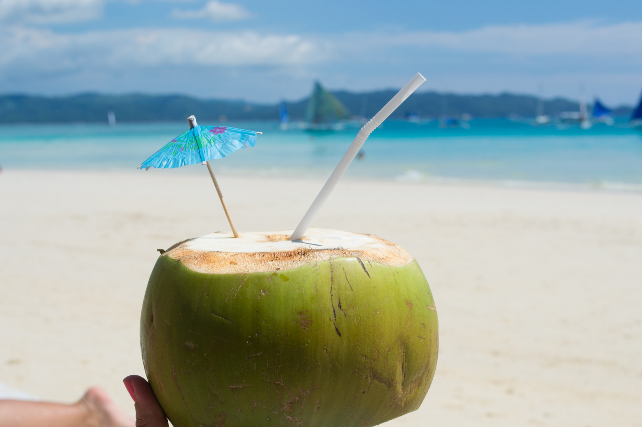 Sipping coconuts in Boracay.