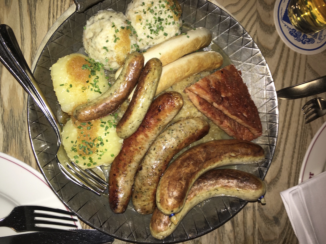 What to eat in Germany: a plate full of different kinds of sausages of course.