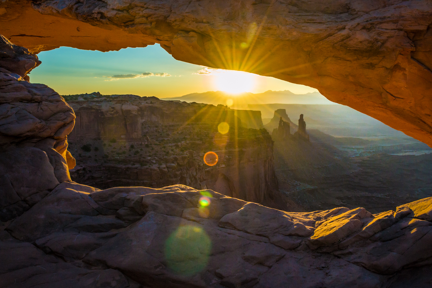 The sunrise at the Mesa Arch at Canyonlands National Park makes the arch glow orange!