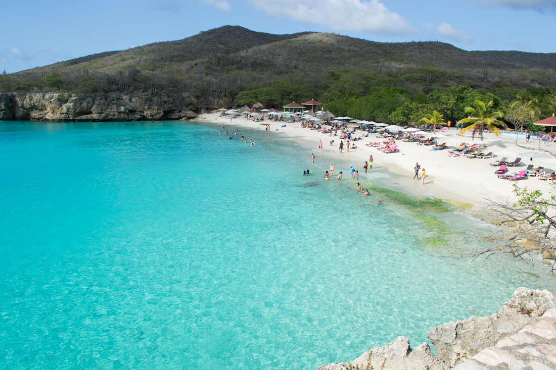 Cliff jumping into gorgeous turquoise water at Playa Kenepa in Curacao.