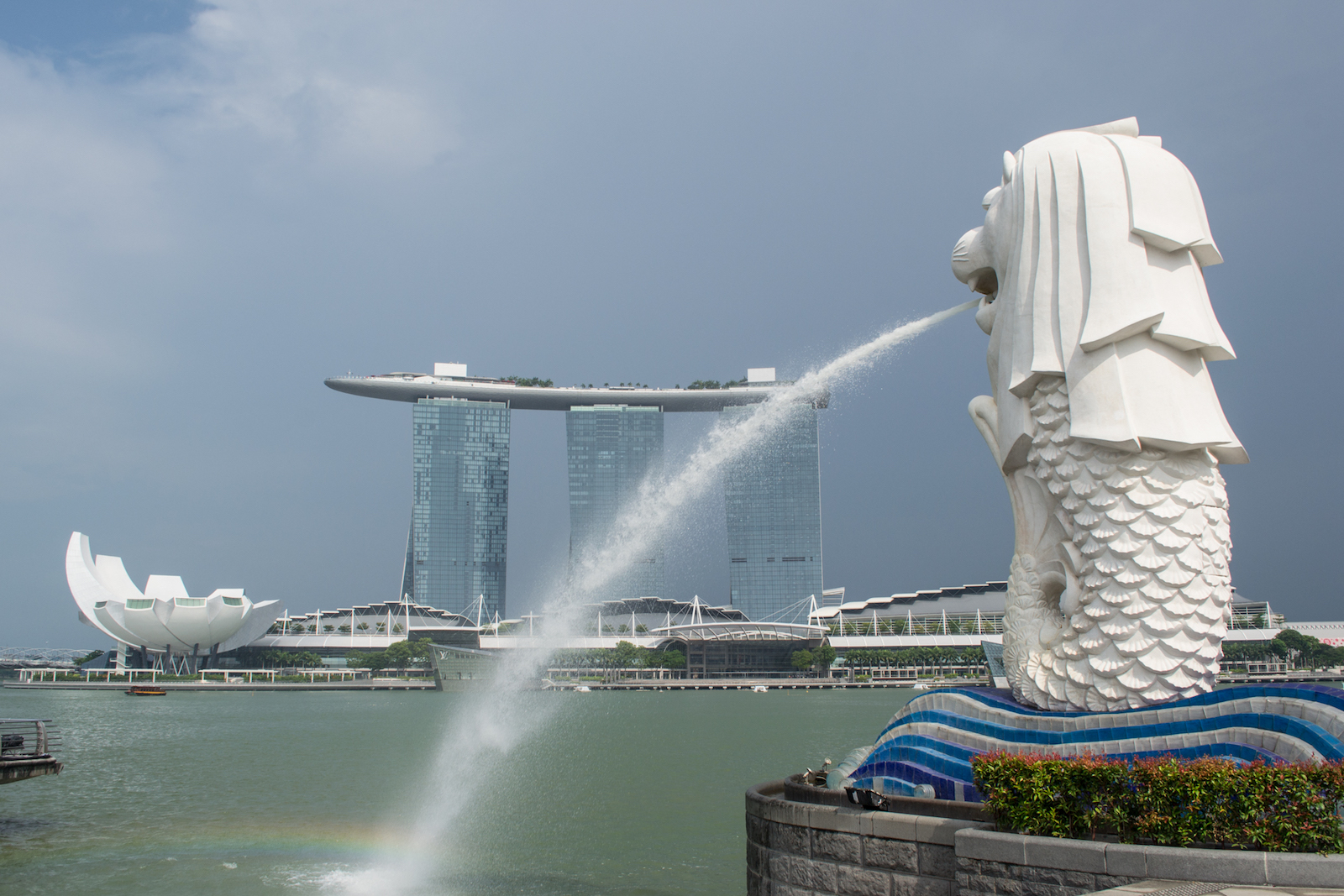 The Marina Bay Sands Hotel behind the Merlion Statue in Singapore at Merlion Park.