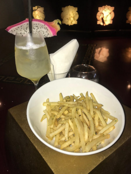 Truffle fries and dragon fruit drink at the Villa Casa Casuarina bar. 