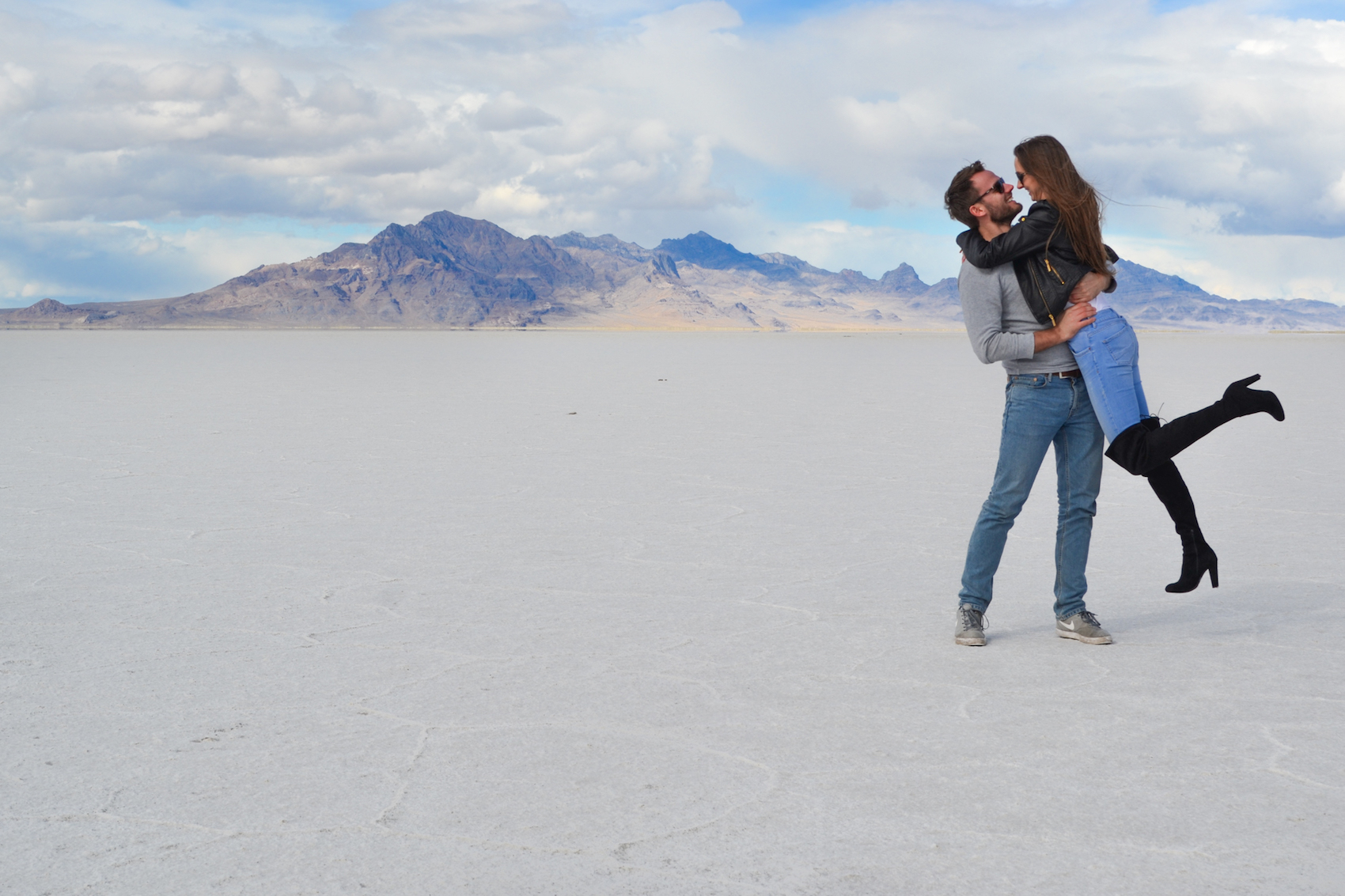 The Bonneville Salt flats are an endless view of white salt with purple mountains in the distance.