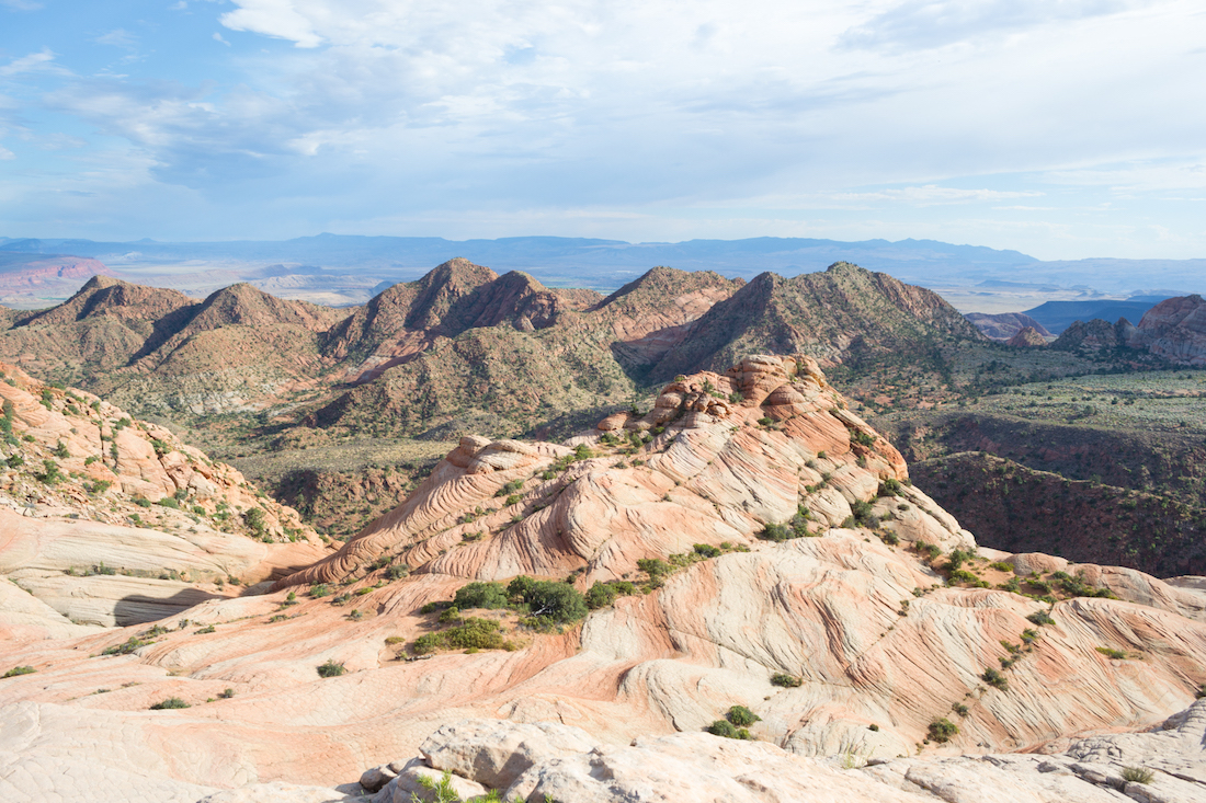While hiking Yant Flat, you'll see orange and white striped rocks and a beautiful mountain backdrop.