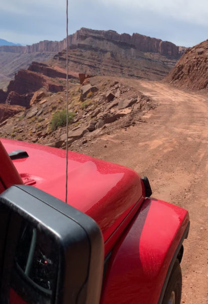 Driving along the Gemini Bridges trail in Moab, Utah in our red Jeep Wrangler. 