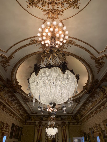 One of the chandeliers and ornate ceilings inside the Flagler Museum. 