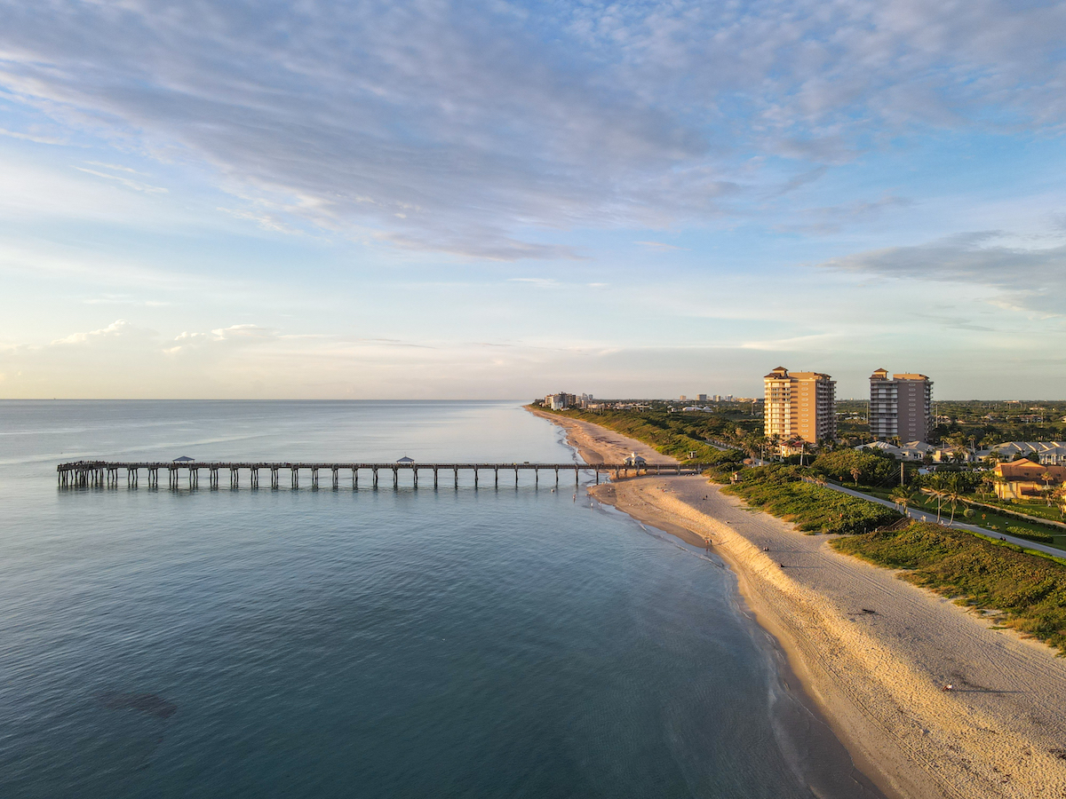 An aerial view of the Juno Beach Pier in Florida at sunrise. 