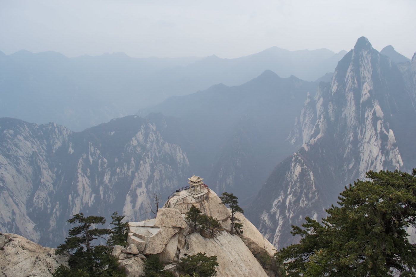 At Mount Huashan in China, there is a tiny pavilion on the top of a mountain that overlooks the mountains around it.