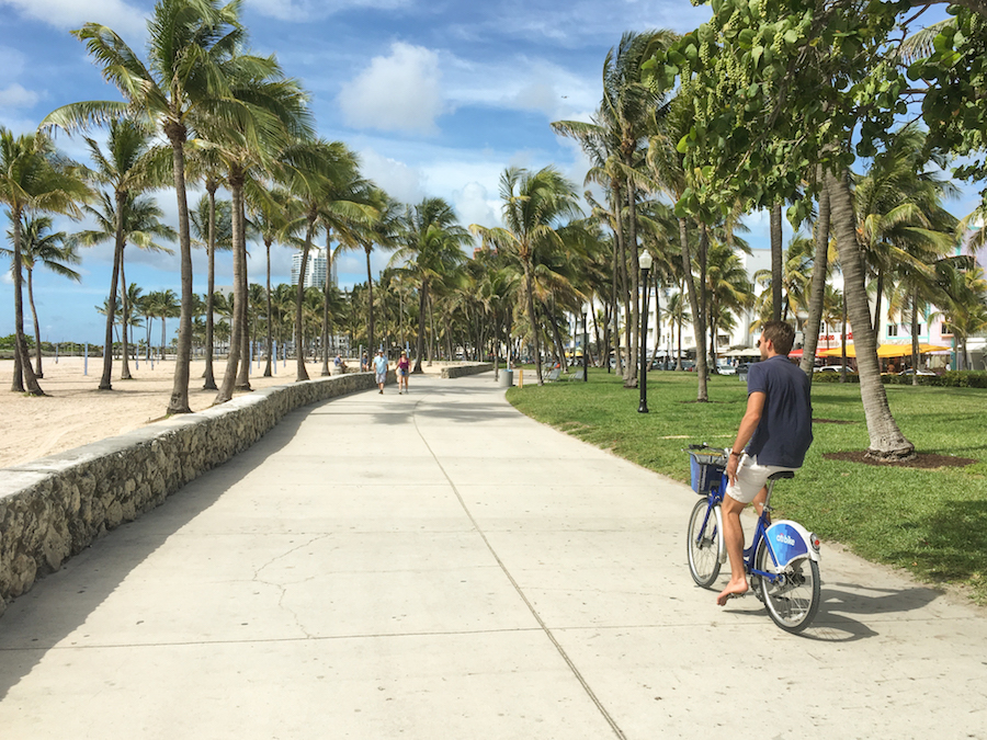 Riding a bicycle down the boardwalk near Ocean Drive.