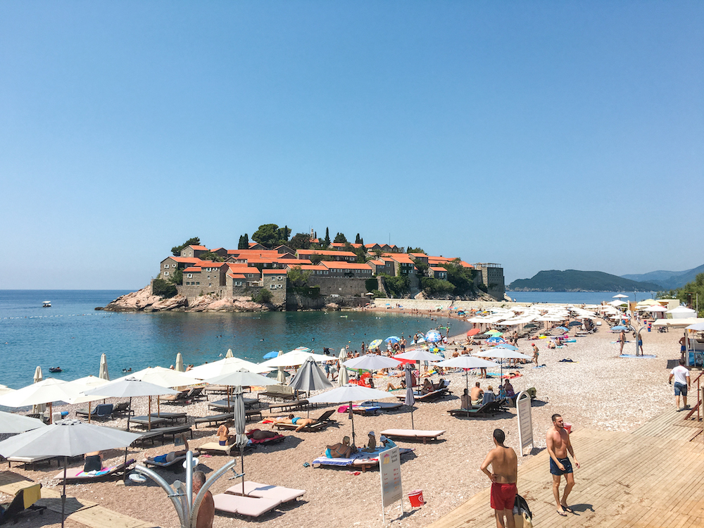 The private island in Sveti Stefan is surrounded by water and has beaches on both sides of the walkway.