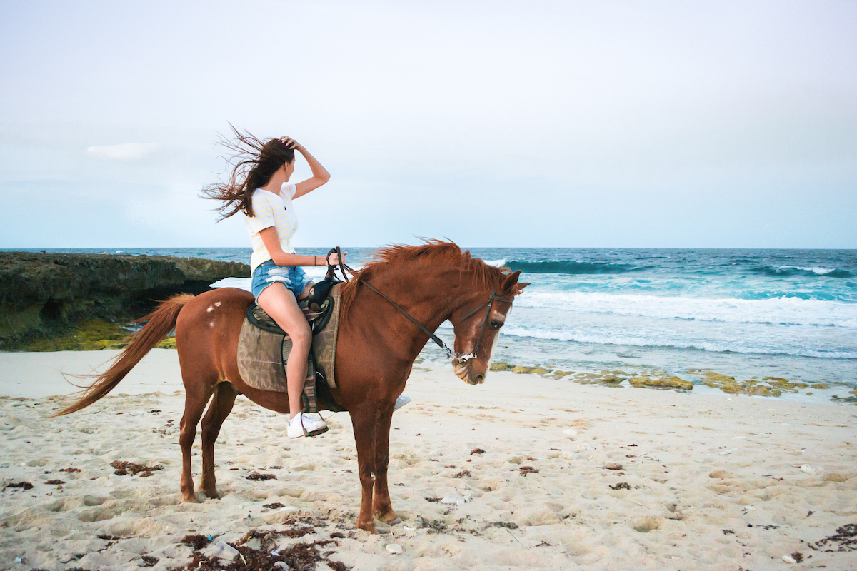 Horseback riding on a beach in Aruba.