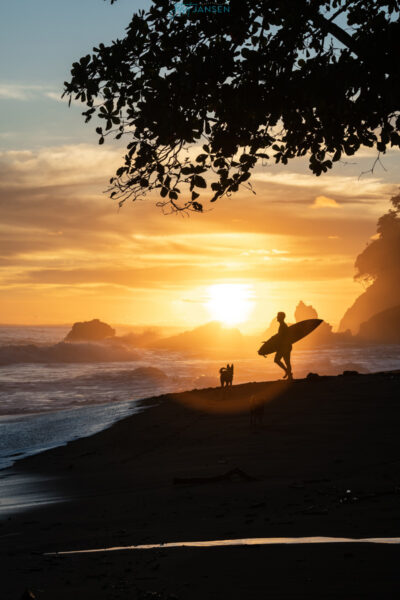 A surfer at sunset in Playa Hermosa Puntarenas, Costa Rica.