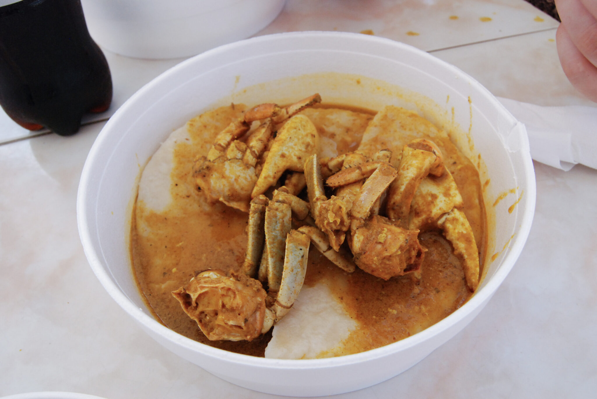Eating curry crab and dumplings in Tobago.