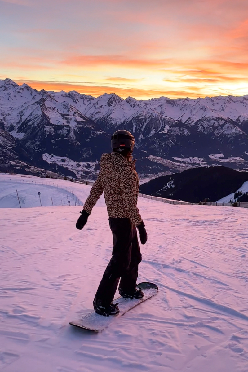 Snowboarding in the Austrian Alps at sunset.