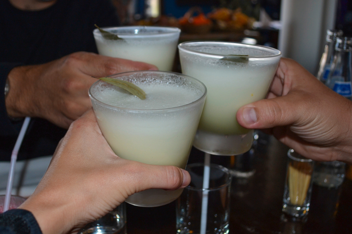 Trying Pisco sours in Peru, a traditional cocktail.