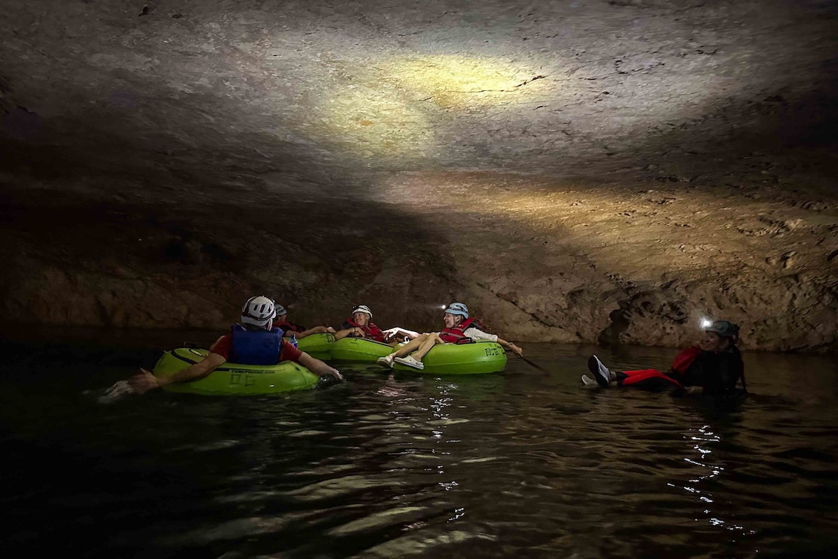 Cave tubing in the dark.