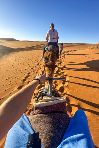 Riding a camel in the Sahara Desert.