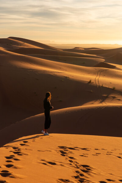 Watching the sunrise in the Sahara Desert.