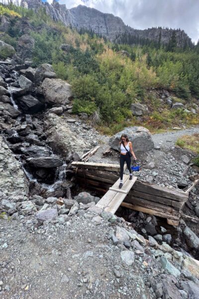Hiking in Colorado near a small waterfall.